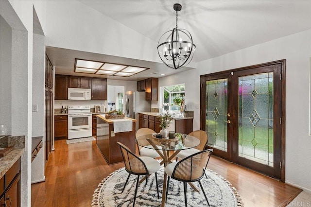 4772 Gateshead Rd, Carlsbad, CA 92010 - dining room featuring light wood-style flooring, french doors, a chandelier, and lofted ceiling