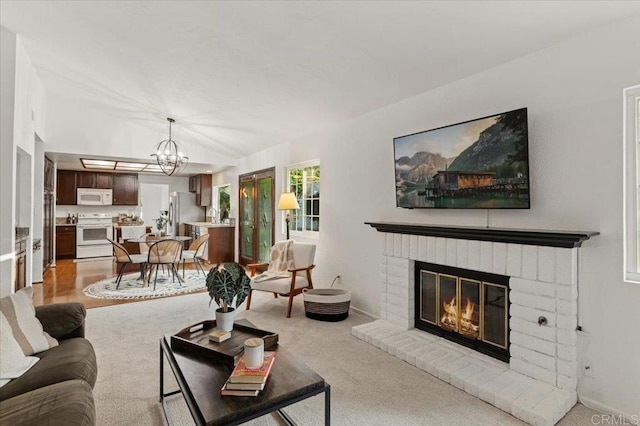 4772 Gateshead Rd, Carlsbad, CA 92010 - living area featuring a chandelier, a fireplace, and light carpet