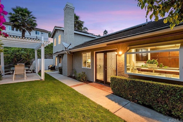 4772 Gateshead Rd, Carlsbad, CA 92010 - back of house with a pergola, stucco siding, a patio, and a chimney