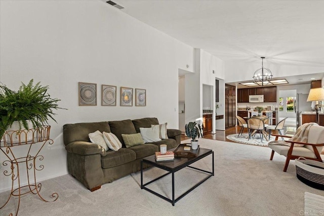 4772 Gateshead Rd, Carlsbad, CA 92010 - carpeted living room with a chandelier and vaulted ceiling