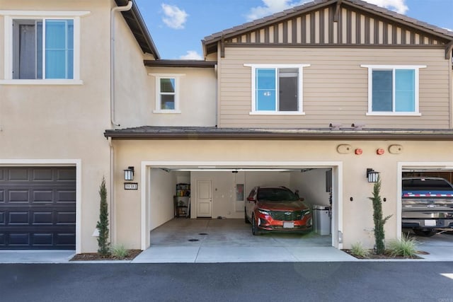 39381 Corvina Ln, Temecula, CA 92591 - rear view of property featuring stucco siding, a garage, and driveway