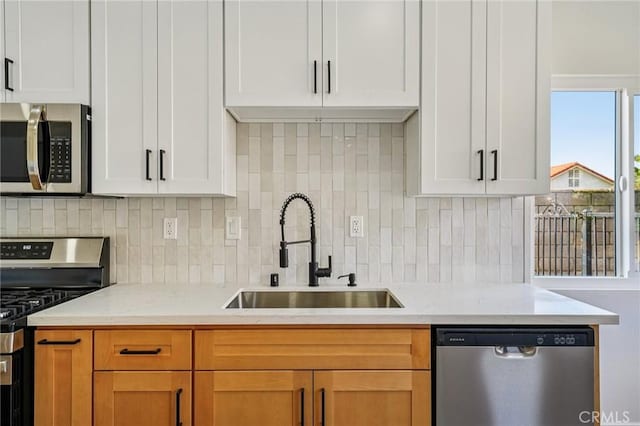 7652 Plumaria, Fontana, CA 92336 - kitchen with appliances with stainless steel finishes, decorative backsplash, white cabinetry, and light stone counters
