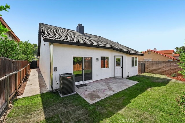 7652 Plumaria, Fontana, CA 92336 - back of house with a fenced backyard, a chimney, a tiled roof, a patio, and stucco siding