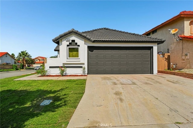 7652 Plumaria, Fontana, CA 92336 - view of front of property featuring a tile roof, a front lawn, driveway, a garage, and stucco siding