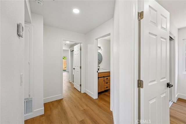 7652 Plumaria, Fontana, CA 92336 - corridor featuring light wood finished floors and recessed lighting