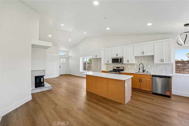 7652 Plumaria, Fontana, CA 92336 - kitchen featuring stainless steel appliances, backsplash, light countertops, wood finished floors, and recessed lighting