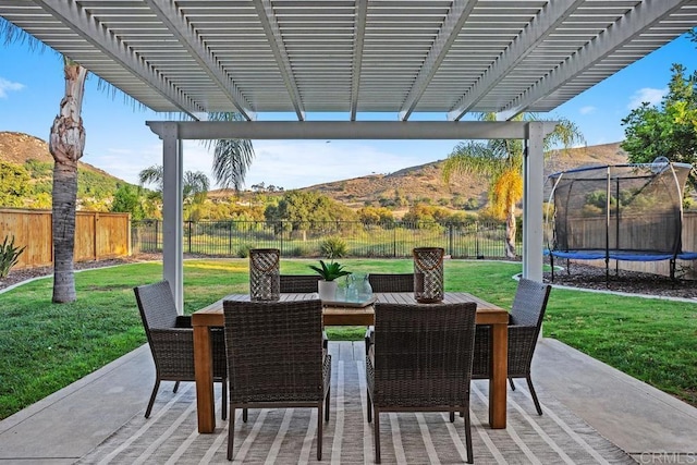 3071 Sprucewood Ln, Escondido, CA 92027 - fenced backyard with a trampoline, outdoor dining area, a mountain view, a pergola, and a patio