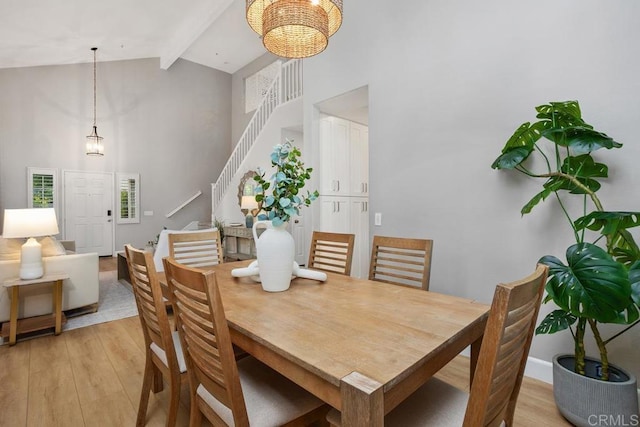3071 Sprucewood Ln, Escondido, CA 92027 - dining space with high vaulted ceiling, stairway, beamed ceiling, light wood finished floors, and a chandelier