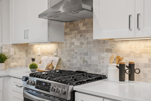 3071 Sprucewood Ln, Escondido, CA 92027 - kitchen featuring wall chimney exhaust hood, gas stove, white cabinetry, and light countertops