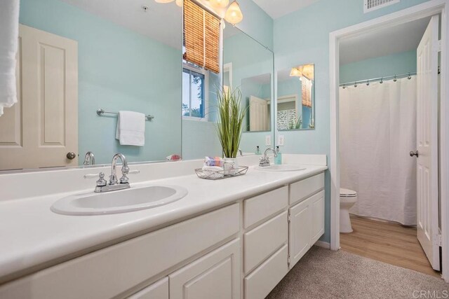 3071 Sprucewood Ln, Escondido, CA 92027 - full bathroom with double vanity and wood finished floors