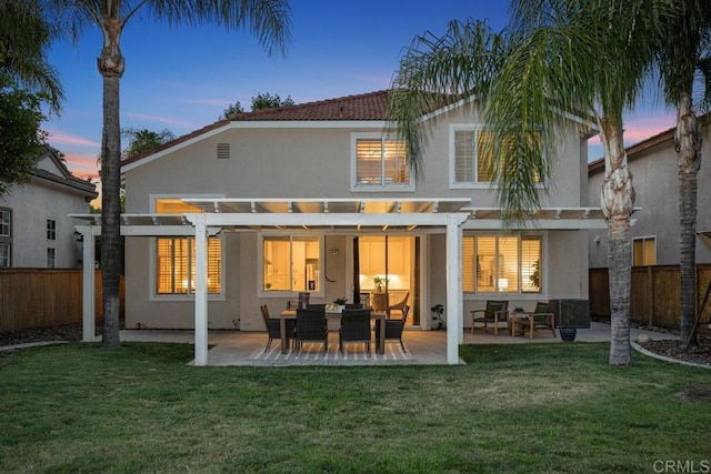 3071 Sprucewood Ln, Escondido, CA 92027 - back of house at dusk with stucco siding, a pergola, a fenced backyard, and a patio