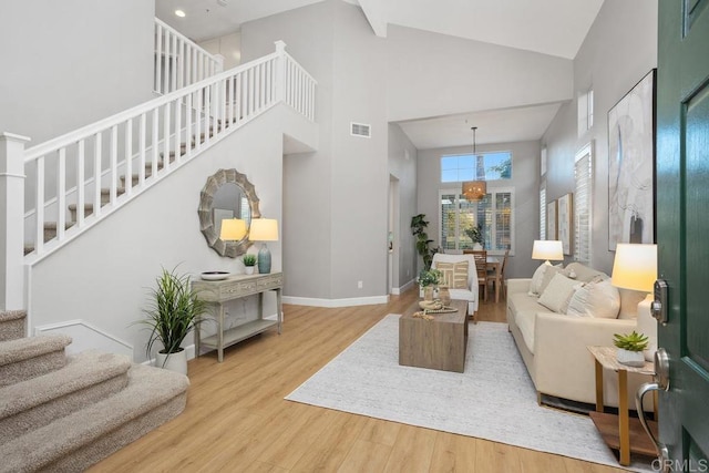 3071 Sprucewood Ln, Escondido, CA 92027 - living area with stairway, high vaulted ceiling, wood finished floors, and a chandelier