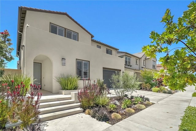 9876 Skylar Ave, Fountain Valley, CA 92708 - mediterranean / spanish house featuring stucco siding, a garage, and driveway