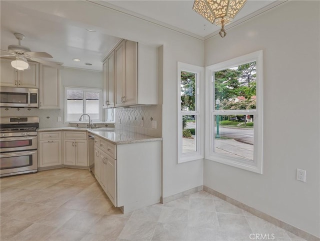 1017 Cordova Ave, Glendale, CA 91207 - kitchen featuring appliances with stainless steel finishes, tasteful backsplash, a ceiling fan, cream cabinetry, and recessed lighting