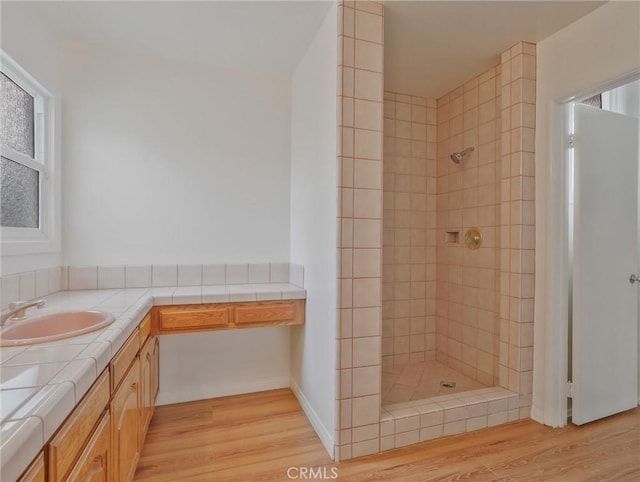 1017 Cordova Ave, Glendale, CA 91207 - full bathroom with tiled shower, wood finished floors, and vanity