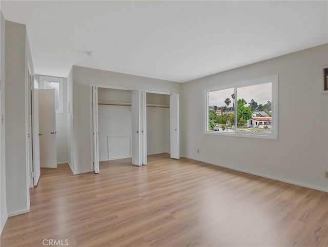 1017 Cordova Ave, Glendale, CA 91207 - unfurnished bedroom with light wood-style flooring and two closets