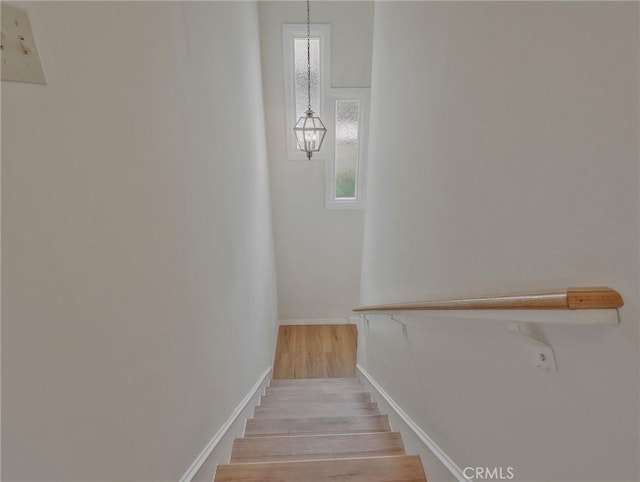 1017 Cordova Ave, Glendale, CA 91207 - stairs featuring wood finished floors and a chandelier