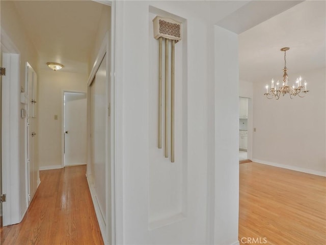 1017 Cordova Ave, Glendale, CA 91207 - hallway featuring light wood-style flooring and a chandelier