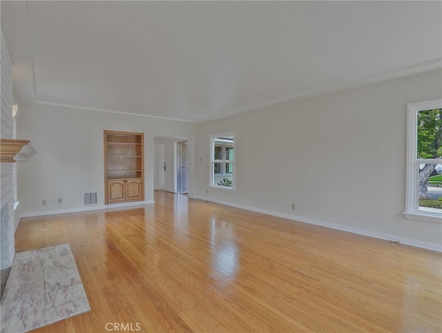 1017 Cordova Ave, Glendale, CA 91207 - unfurnished living room featuring a fireplace with flush hearth, wood finished floors, and built in shelves
