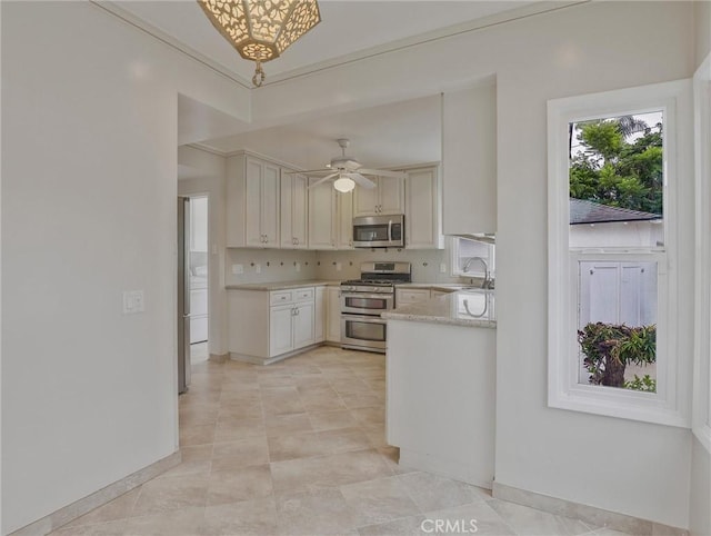 1017 Cordova Ave, Glendale, CA 91207 - kitchen featuring stainless steel appliances, light countertops, cream cabinets, a ceiling fan, and washer / dryer