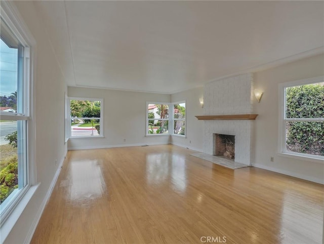 1017 Cordova Ave, Glendale, CA 91207 - unfurnished living room with wood finished floors, healthy amount of natural light, and a brick fireplace