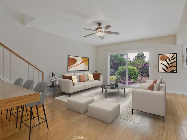 1017 Cordova Ave, Glendale, CA 91207 - living room featuring light wood-type flooring, ceiling fan, and stairway