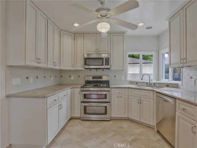 1017 Cordova Ave, Glendale, CA 91207 - kitchen featuring appliances with stainless steel finishes, decorative backsplash, cream cabinetry, a ceiling fan, and light stone countertops