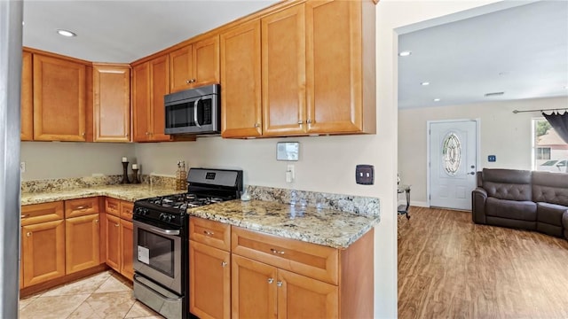 14658 Maclay St, San Fernando, CA 91345 - kitchen featuring appliances with stainless steel finishes, open floor plan, light stone counters, recessed lighting, and brown cabinets