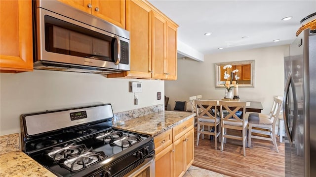14658 Maclay St, San Fernando, CA 91345 - kitchen with appliances with stainless steel finishes, light stone countertops, and recessed lighting