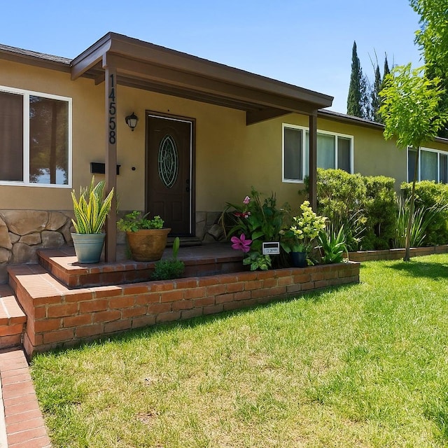 14658 Maclay St, San Fernando, CA 91345 - doorway to property featuring a yard and stucco siding