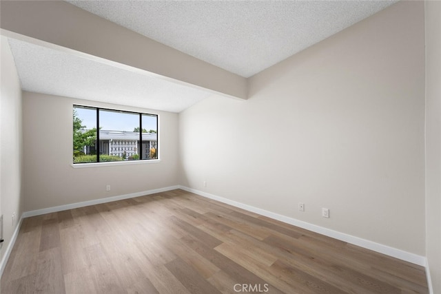 1661 Monterey Rd Unit 16G, Seal Beach, CA 90740 - empty room with wood finished floors and a textured ceiling