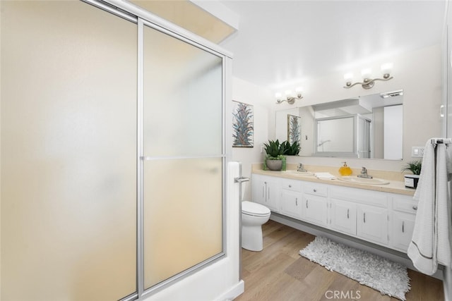 1661 Monterey Rd Unit 16G, Seal Beach, CA 90740 - bathroom with a shower with door, double vanity, and wood finished floors