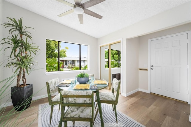 1661 Monterey Rd Unit 16G, Seal Beach, CA 90740 - dining space featuring lofted ceiling, a textured ceiling, light wood finished floors, and a ceiling fan