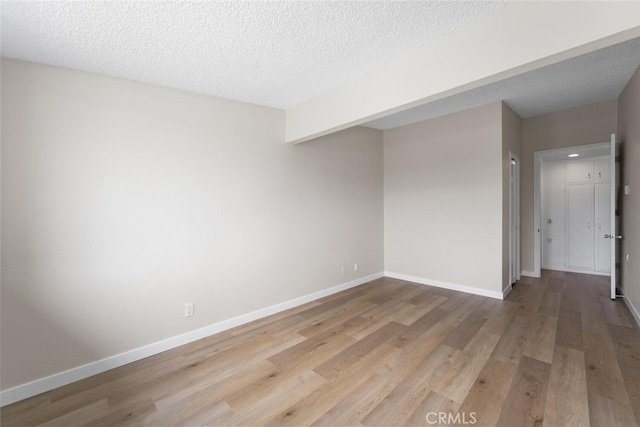 1661 Monterey Rd Unit 16G, Seal Beach, CA 90740 - empty room featuring light wood-type flooring and a textured ceiling