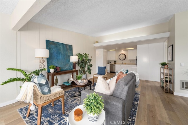 1661 Monterey Rd Unit 16G, Seal Beach, CA 90740 - living area with a textured ceiling and light wood finished floors