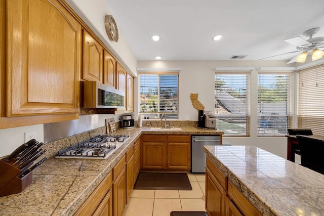 1159 Avenida Azul, San Marcos, CA 92069 - kitchen with stainless steel appliances, a ceiling fan, light tile patterned floors, recessed lighting, and brown cabinets