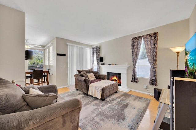 1159 Avenida Azul, San Marcos, CA 92069 - living room featuring a glass covered fireplace, a ceiling fan, and light wood-type flooring