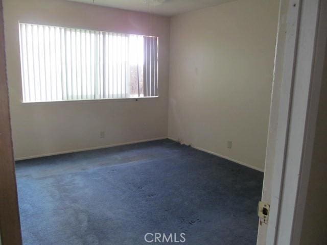 14537 Yucca St, Hesperia, CA 92345 - unfurnished room with plenty of natural light, dark carpet, and ceiling fan