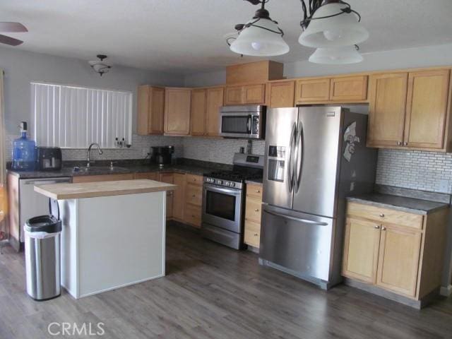 14537 Yucca St, Hesperia, CA 92345 - kitchen with stainless steel appliances, tasteful backsplash, wood finished floors, a center island, and ceiling fan