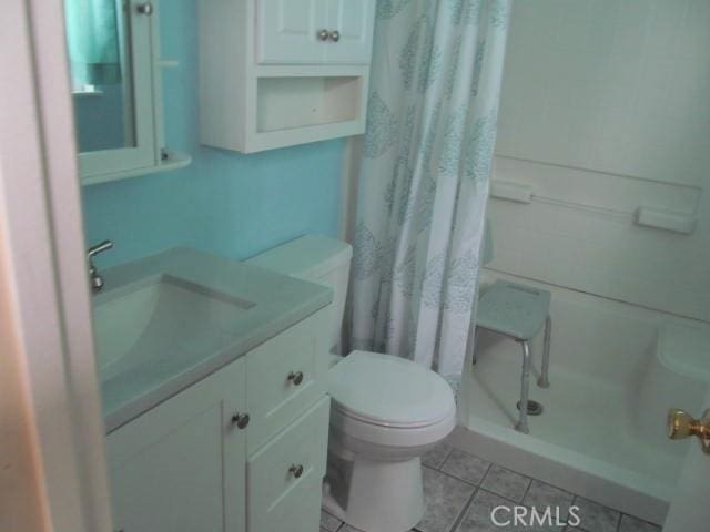 14537 Yucca St, Hesperia, CA 92345 - full bathroom with tile patterned floors, curtained shower, and vanity