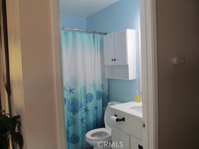 14537 Yucca St, Hesperia, CA 92345 - full bathroom featuring vanity and curtained shower