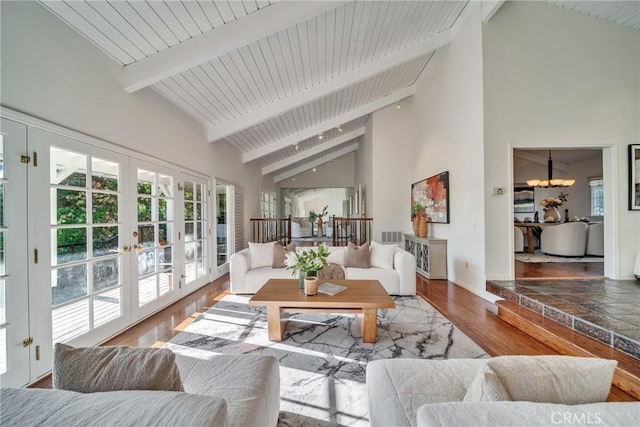 9472 Rembert Ln, Beverly Hills, CA 90210 - living room featuring high vaulted ceiling, plenty of natural light, a chandelier, beam ceiling, and french doors