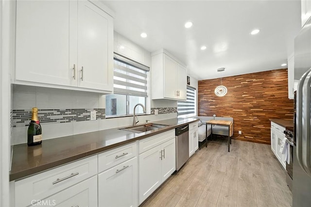 2121 E 1st St Unit 108, Long Beach, CA 90803 - kitchen with stainless steel appliances, dark countertops, white cabinets, light wood finished floors, and recessed lighting