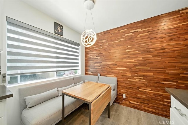 2121 E 1st St Unit 108, Long Beach, CA 90803 - dining area featuring breakfast area, wooden walls, and light wood-style floors