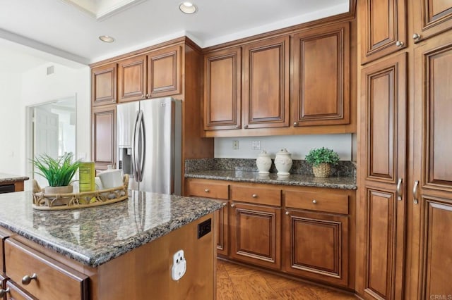 3309 Caminito Cabo Viejo, Del Mar, CA 92014 - kitchen featuring stainless steel fridge, brown cabinetry, a center island, dark stone counters, and recessed lighting
