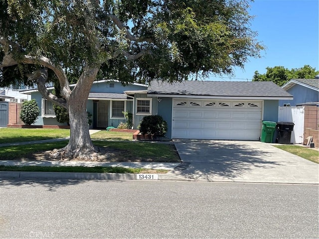 13431 Olympus Dr, Westminster, CA 92683 - view of front of house featuring a garage, concrete driveway, stucco siding, and a front yard
