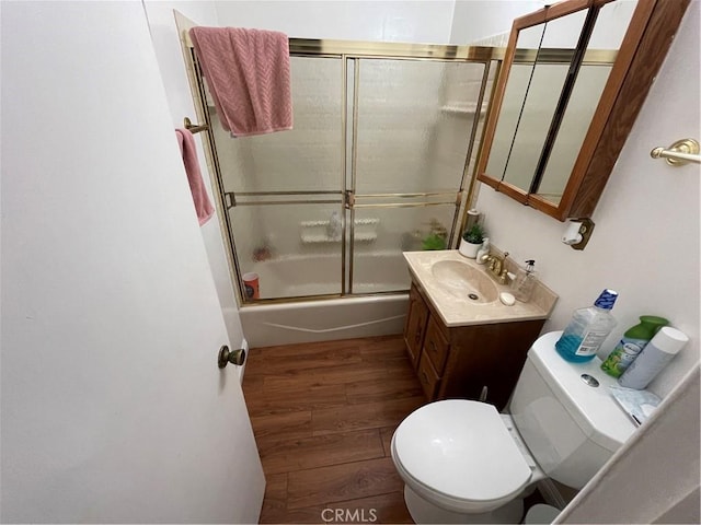 13431 Olympus Dr, Westminster, CA 92683 - bathroom with vanity, shower / bath combination with glass door, and wood finished floors