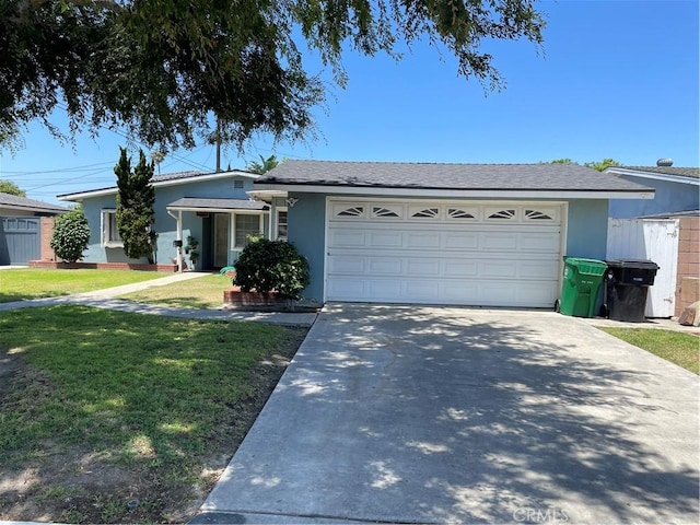 13431 Olympus Dr, Westminster, CA 92683 - ranch-style home with stucco siding, driveway, a front lawn, and an attached garage