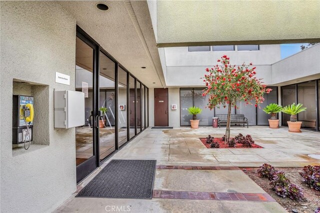 3486 Bahia Blanca W Unit 3F, Laguna Woods, CA 92637 - property entrance featuring stucco siding