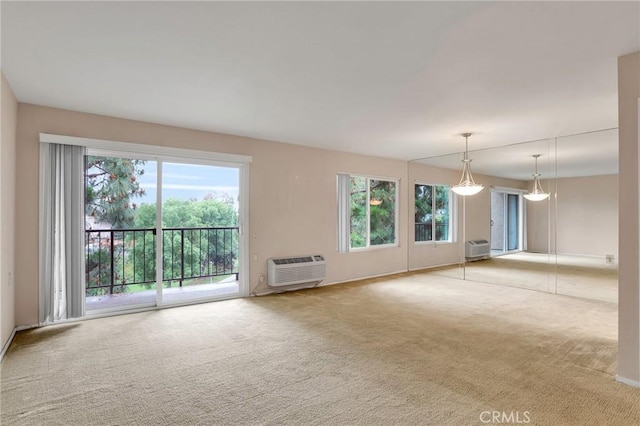 3486 Bahia Blanca W Unit 3F, Laguna Woods, CA 92637 - unfurnished living room with carpet floors, healthy amount of natural light, and a wall unit AC
